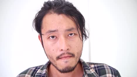 Hipster-portrait.-Asian-man-with-sad-emotional-look-at-camera,-sad-mood.