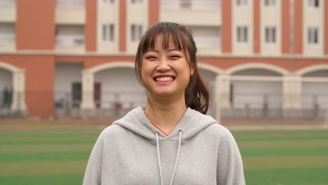 Portrait-of-young-asian-girl-smile-at-camera-in-campus