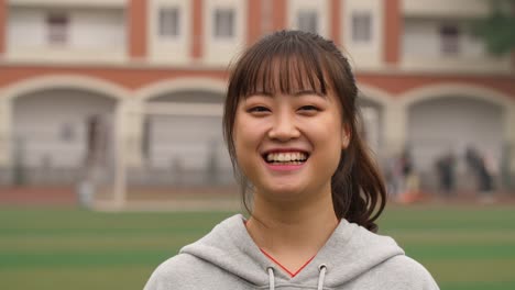 Portrait-of-young-asian-girl-smile-at-camera-in-campus