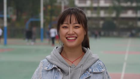 Portrait-of-young-asian-girl-smile-at-camera-in-campus