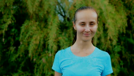 Portrait-of-a-beautiful-woman-in-the-summer-rain.-Woman-looking-at-the-camera