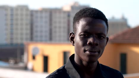 Confident-attractive-young-african-man-looking-at-camera--outdoor