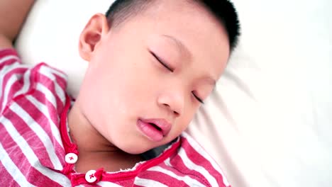 Boy-sleeping-on-bed