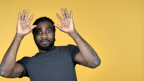 Casual-African-Man-Confused-and-Scared-of-Problems-Isolated-on-Yellow-Background