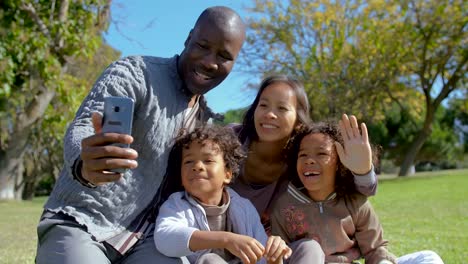 Happy-Interracial-family-waving-and-having-video-chat