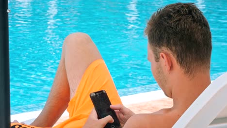 Young-boy-relaxing-on-the-chaise-longue