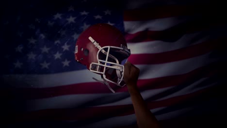 American-football-player-holds-his-helmet-up-in-air