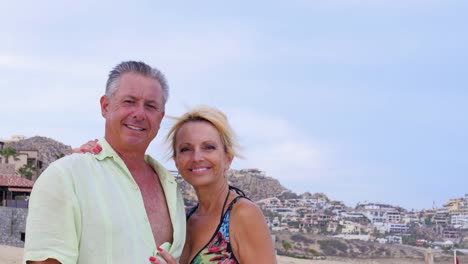 Portrait-of-an-older-couple-standing-on-the-beach