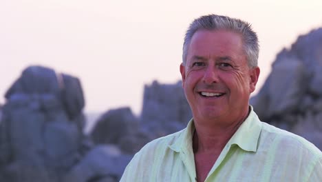 Close-up-portait-of-an-older-man-standing-on-the-beach