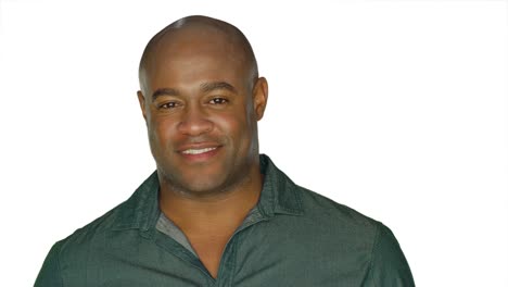 Handsome-man-stares-and-smiles-charmingly,-on-a-white-studio-background