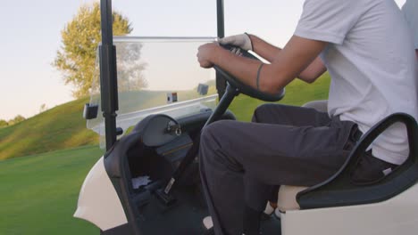 Close-up-of-golf-cart-and-riders