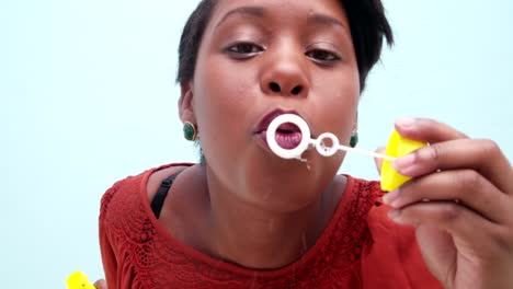 Childish-young-african-woman-blowing-bubbles