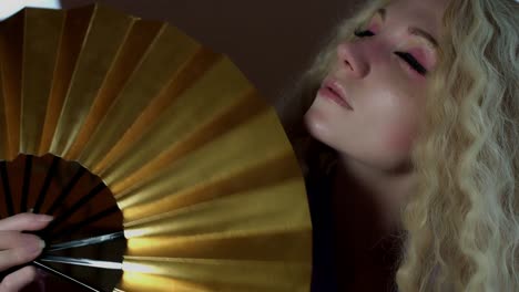 4k-Fantasy-Shot-of-a-Fairy-Posing-with-a-Golden-Fan