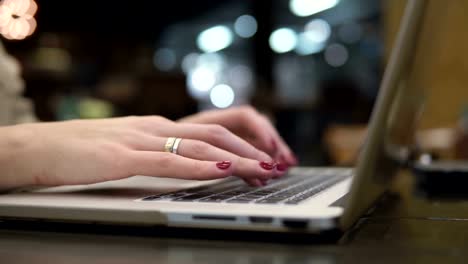 Closeup-hands.-Businesswoman-working-on-laptop-in-modern-cafe-4k