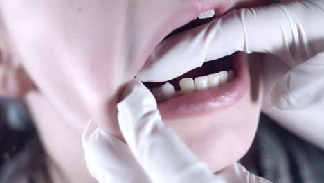 4k-Close-Up-Child-Doctor-Showing-Wiggling-Tooth