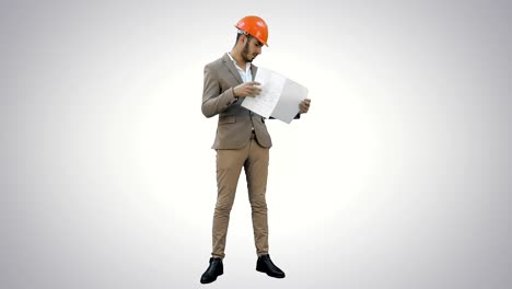 Young-architect-in-helmet-checking-construction-plans-on-white-background