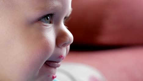 An-attractive-boy-2-years-old-eats-a-red-beet-salad.-The-face-is-smeared-with-porridge.-Sits-on-the-table.-Close-up