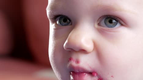 An-attractive-boy-2-years-old-eats-a-red-beet-salad.-The-face-is-smeared-with-porridge.-Sits-on-the-table.-Close-up