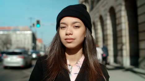 Portrait-of-young-African-American-woman-looking-to-a-camera,-outdoors.