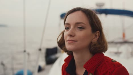 Portrait-of-a-young-woman-is-relaxing-on-a-sailing-boat-in-the-sea.