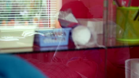 Reflection-in-the-window-of-the-cosmetology-room,-the-eyebrow-tattoo-master-performs-his-work