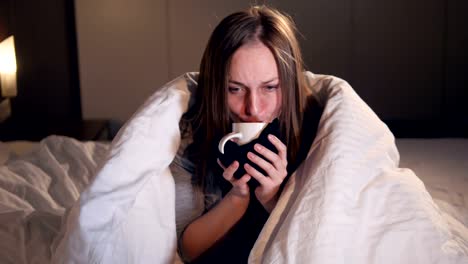 The-portrait-of-the-ill-woman-drinking-the-hot-tea.-Close-up.-4K.