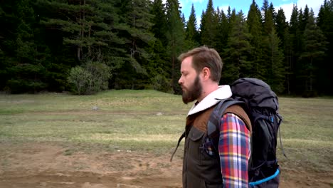 Traveler-with-a-backpack-walking-along-the-lake