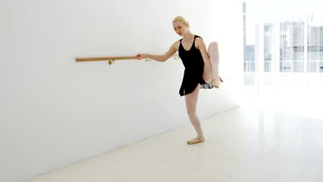 Ballerina-practicing-ballet-dance-at-barre