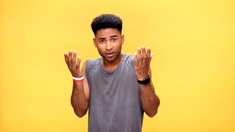 Young-nervous-african-man-says-stop-to-you-over-yellow-background.