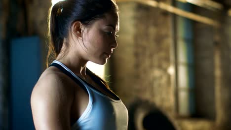 Beautiful-Athletic-Woman-Covered-In-Sweat-Looks-into-Camera.-She's-Tired-after-Intensive-Cross-Fitness-Exercise.