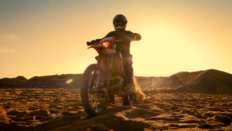 Low-Angle-Shot-of-the-Professional-Motocross-Driver-Sitting-on-His-FMX-Motorcycle-Twisting-Full-Throttle-Handle-and-Starting-to-Ride-This-Extreme-Off-Road-Terrain-Track