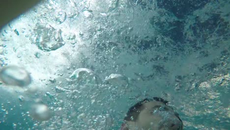 Man-having-fun-and-sliding-down-in-a-water-slide