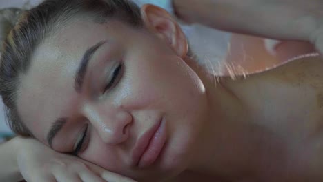 Portrait-of-young-beautiful-woman-at-skin-care-spa-salon,-close-up-slow-motion.