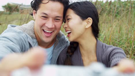 Portrait-Asian-Chinese-Young-Couple-Smiling-Filming-Selfie