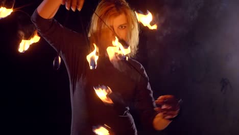 Yong-woman-artist-performing-fire-show-at-dark-in-slow-motion.