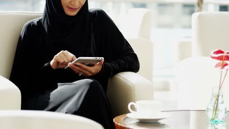 Emirati-businesswoman-using-wireless-tablet-technology-downtown-hotel