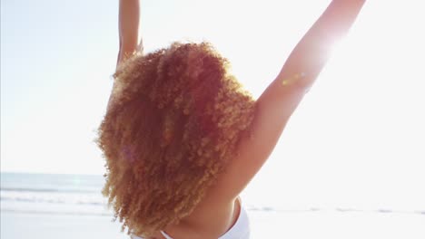 Portrait-of-Ethnic-female-relaxing-on-sunset-beach