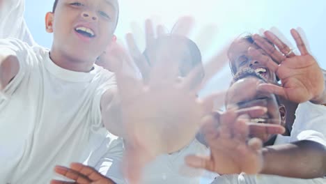 Portrait-of-family-making-video-diary-on-beach