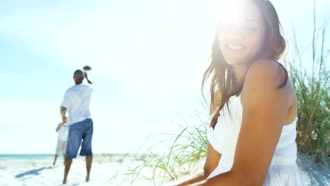 Portrait-of-young-ethnic-female-sitting-on-beach