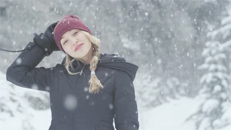 Portrait-shot-of-a-beautiful-young-Asian-woman-smiling-on-a-snowy-day