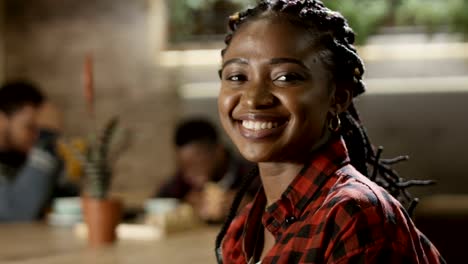 Retrato-de-sonriente-negro-mujer-en-café