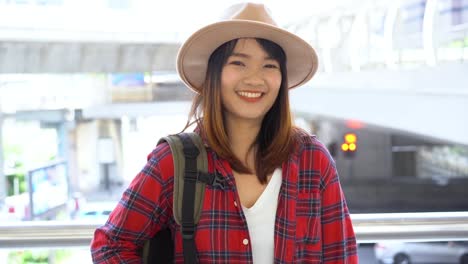 Attractive-young-smiling-Asian-woman-outdoors-portrait-in-the-city-real-people-series.-Outdoors-lifestyle-fashion-portrait-of-happy-smiling-Asian-girl.-Summer-outdoor-happiness-portrait-concept.