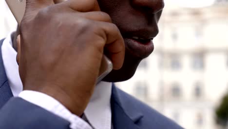 close-up-on-black-businessman-talking-on-the-phone