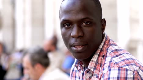 Handsome-young-black--african-man-turning-and-looking-at-camera--outdoor