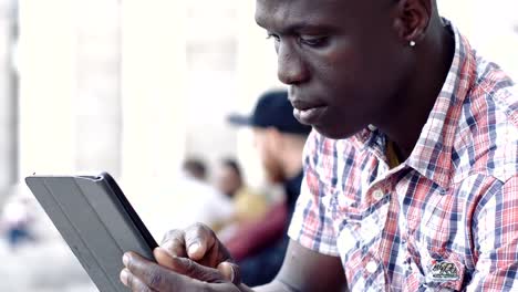 young-African-black-man-uses-the-digital-tablet