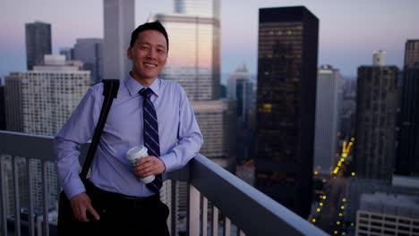 Portrait-of-ethnic-businessman-using-technology-at-sunrise