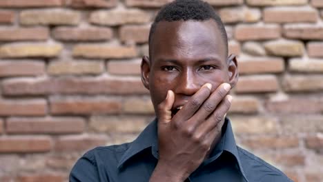 young-black-african-man-yawns,looking-at-camera