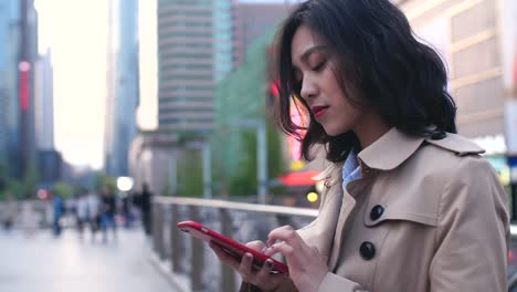 young-asian-woman-using-smartphone-in-the-city