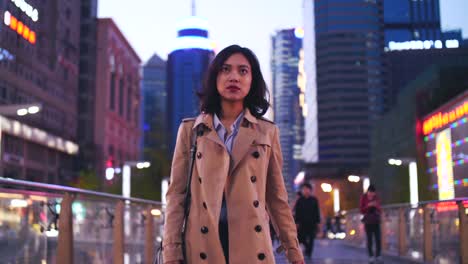 slow-motion--of-one-pretty-happy-young-asian-woman-walking-in-the-city-street--at-evening