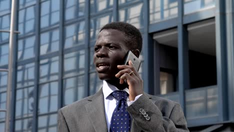 Succesful-confident-black-american-business-man-talking-by-phone-in-the-street